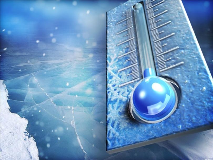 A close-up of a blue thermometer showing a low temperature, set against an icy, snow-covered background with falling snowflakes and cracked ice.